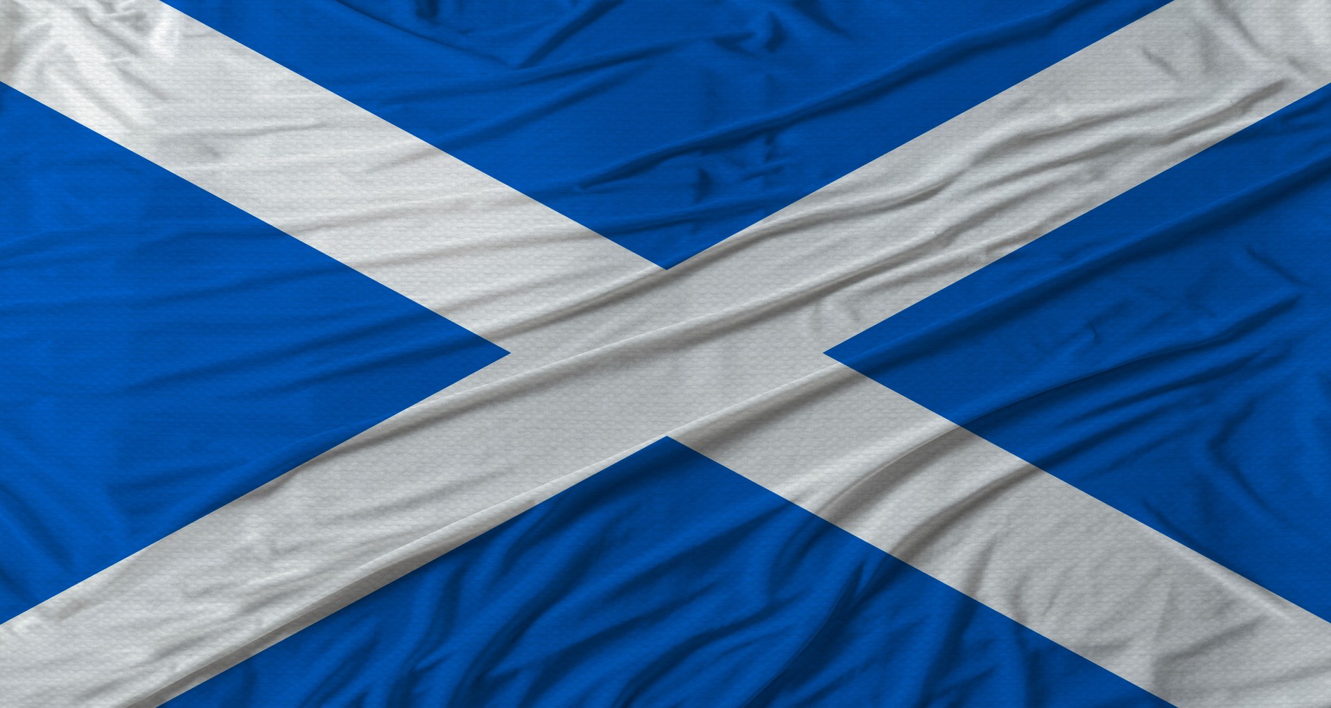 Scottish flag waving. Flag of Scotland with cloth texture